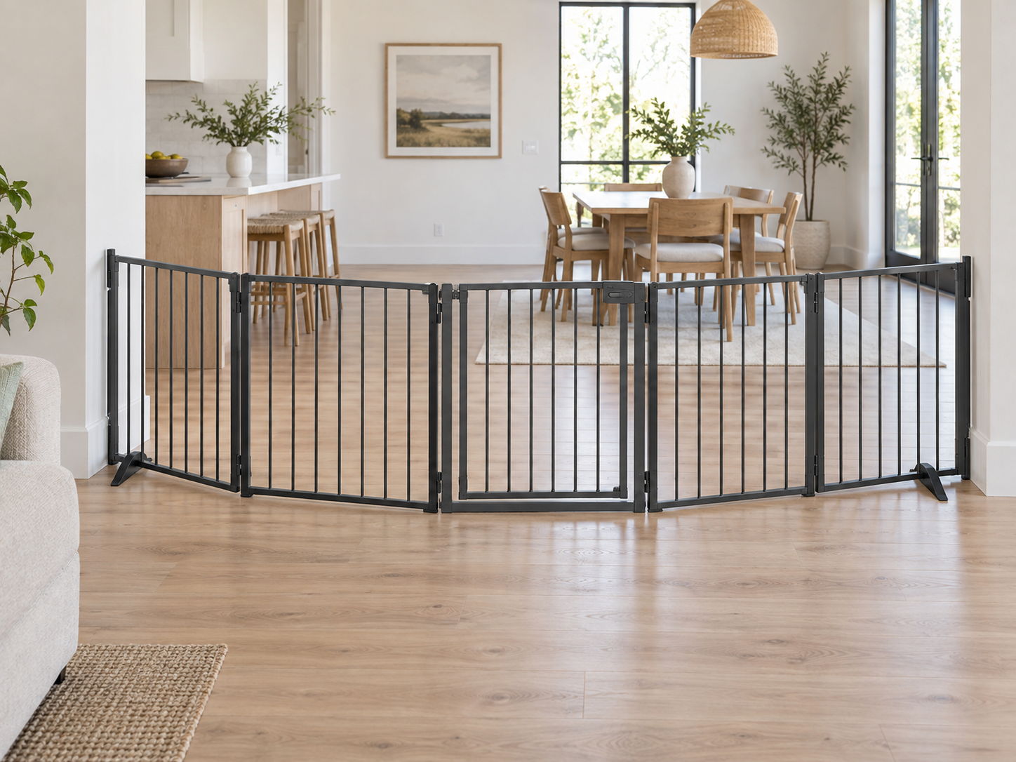 Configurable hinged metal pet gate arranged across a wide open-plan room transition